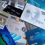 Close-up image of various credit cards including Visa, Mastercard, and American Express.